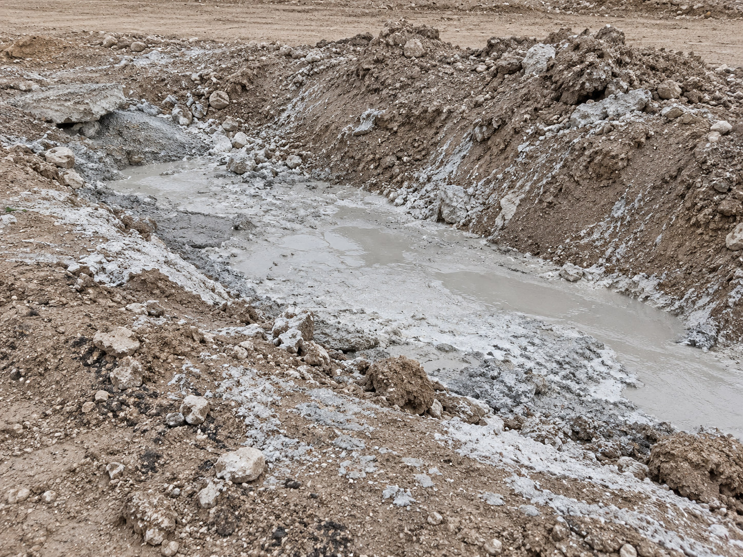 Concrete slurry in an excavated earthen trench