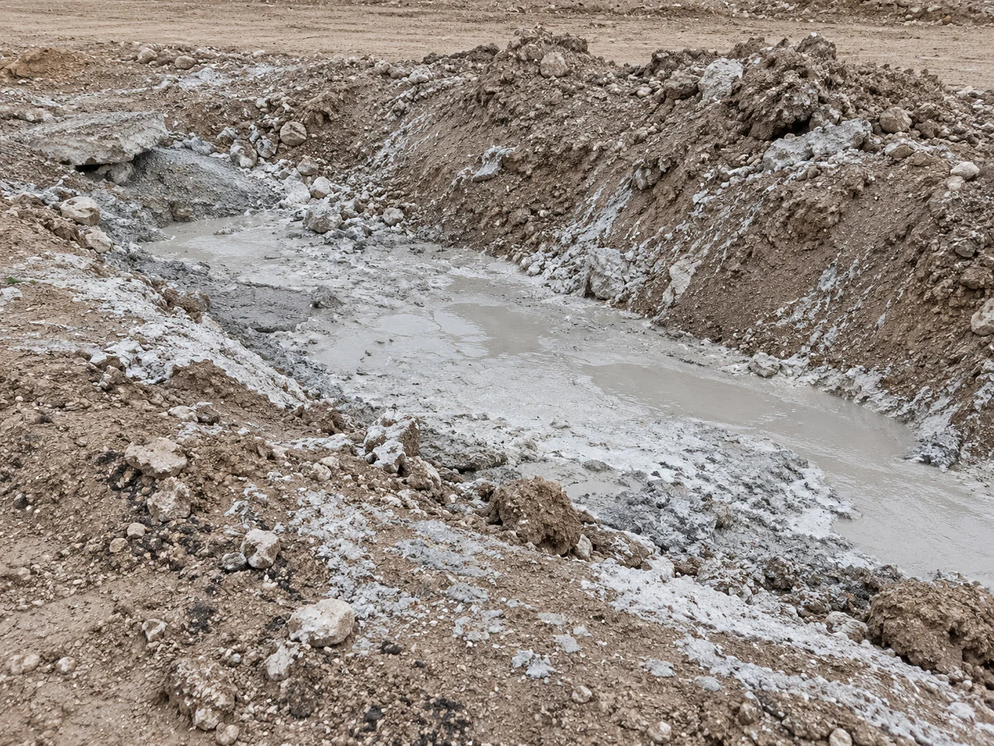 Concrete slurry in an excavated earthen trench